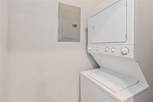 clothes washing area with stacked washer / dryer