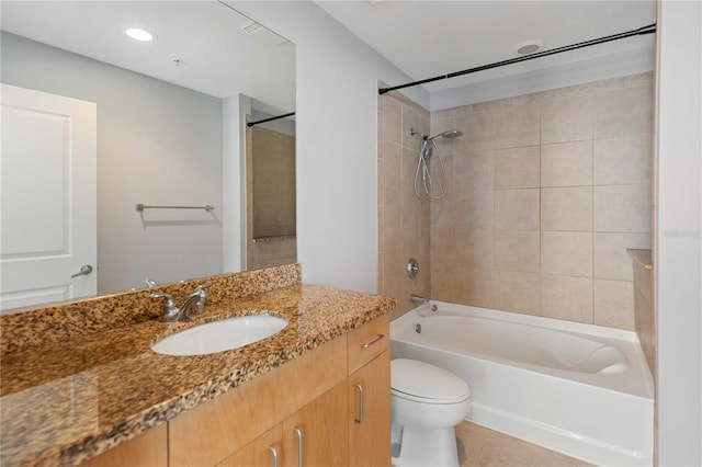 full bathroom with oversized vanity, tiled shower / bath combo, toilet, and tile floors