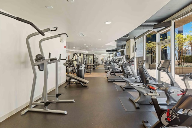 gym with a wall of windows