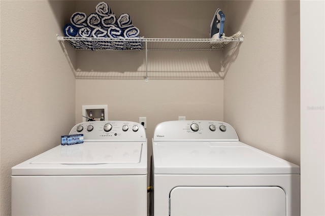 laundry room featuring hookup for a washing machine and washing machine and dryer