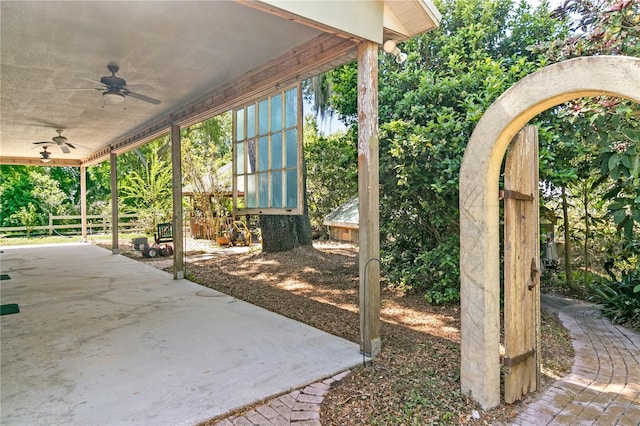 view of patio / terrace with ceiling fan and fence