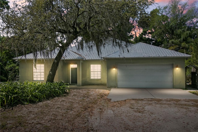 ranch-style home featuring a garage