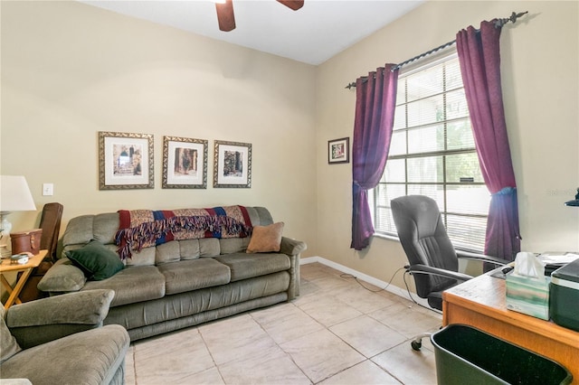 office featuring a ceiling fan, baseboards, and light tile patterned floors