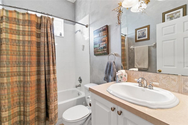 full bath with vanity, toilet, and shower / bath combo with shower curtain