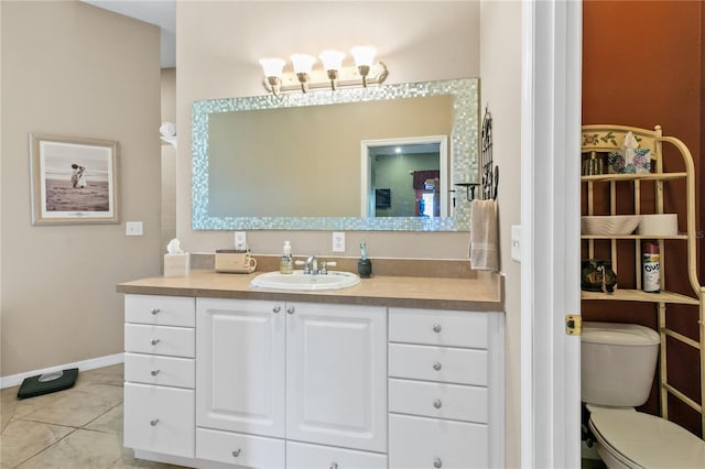 bathroom with baseboards, vanity, toilet, and tile patterned floors