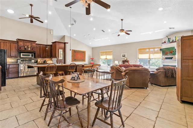 dining space featuring a textured ceiling, high vaulted ceiling, light tile patterned flooring, recessed lighting, and visible vents