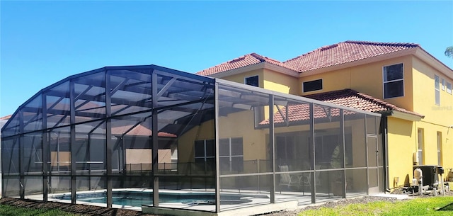 rear view of property with a lanai