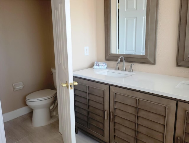 bathroom featuring vanity and toilet