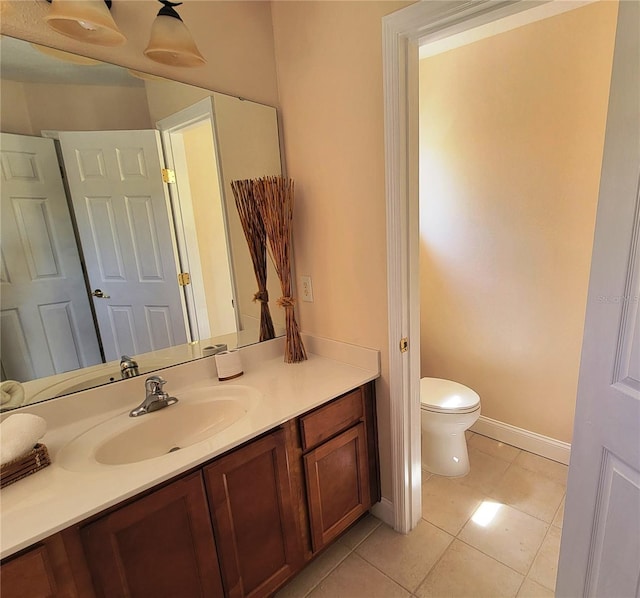 bathroom featuring toilet, vanity, and tile patterned floors