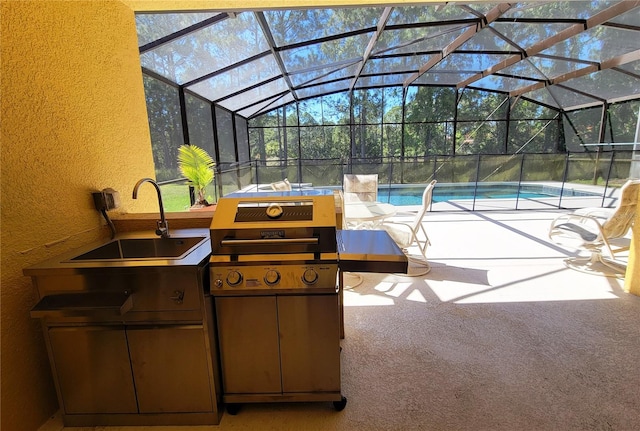 view of patio with area for grilling, a lanai, and sink