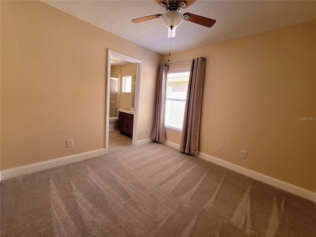 carpeted empty room featuring ceiling fan