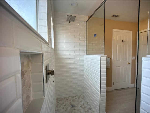 bathroom featuring tiled shower