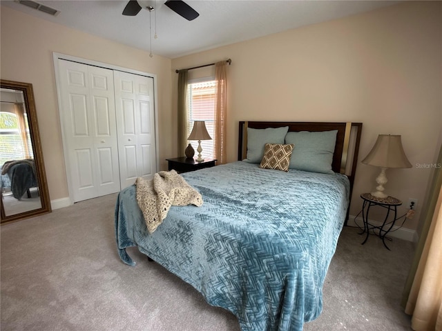 carpeted bedroom featuring ceiling fan and a closet