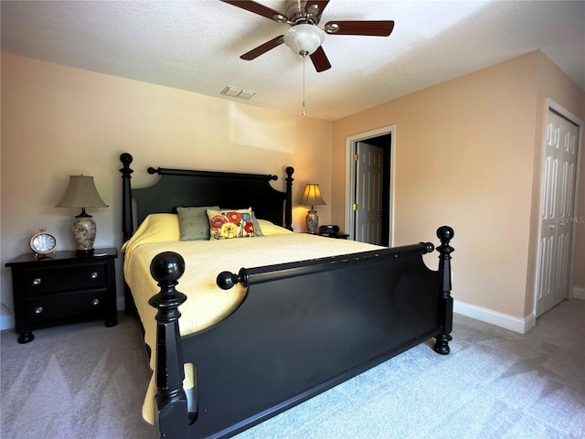 bedroom featuring carpet, ceiling fan, and a textured ceiling