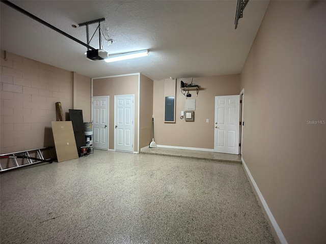 garage with electric panel and a garage door opener