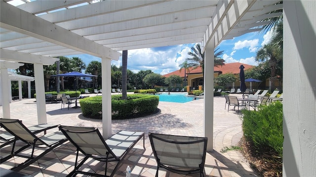 view of patio / terrace featuring a community pool and a pergola