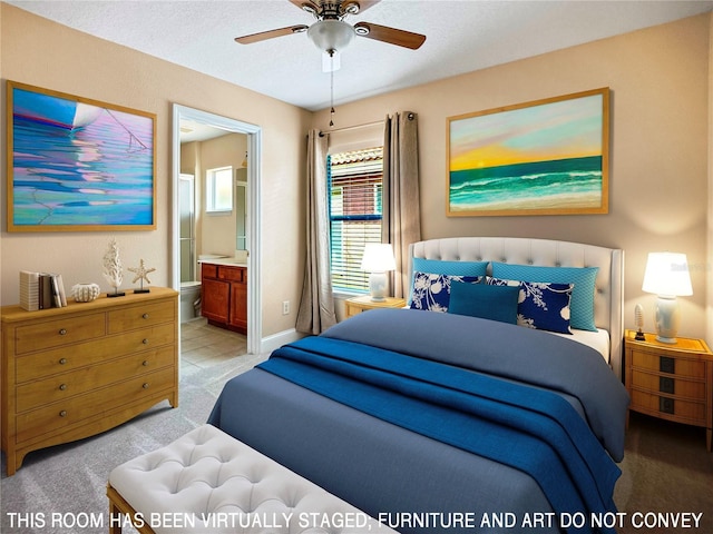 bedroom featuring light carpet, a textured ceiling, ensuite bathroom, and ceiling fan