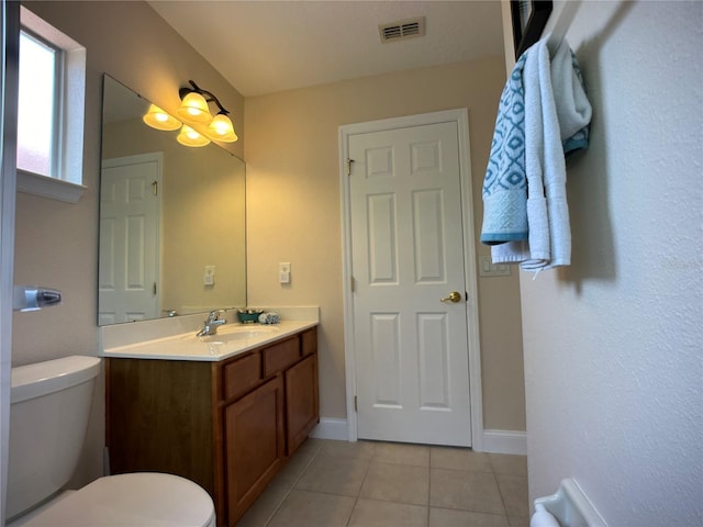 bathroom with tile patterned floors, vanity, and toilet