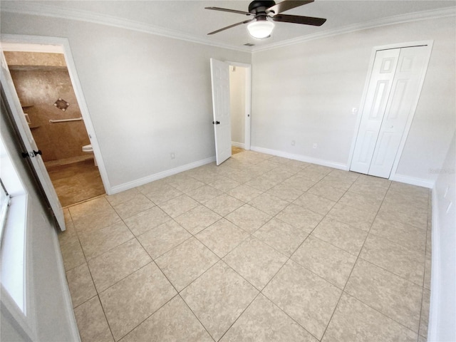 unfurnished bedroom with ensuite bathroom, ornamental molding, ceiling fan, light tile patterned floors, and a closet