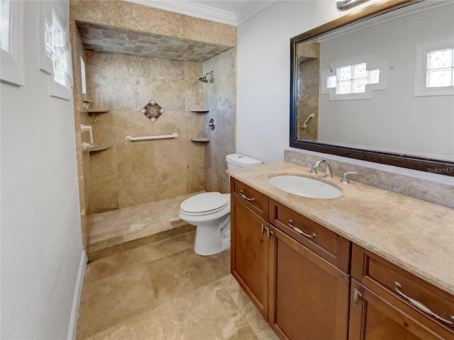 bathroom featuring vanity, toilet, ornamental molding, and tiled shower