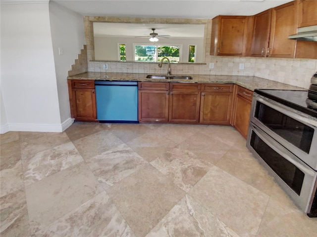 kitchen with ceiling fan, sink, stainless steel appliances, light stone counters, and backsplash