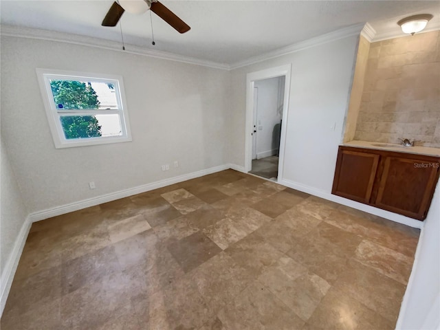 empty room with crown molding, sink, and ceiling fan