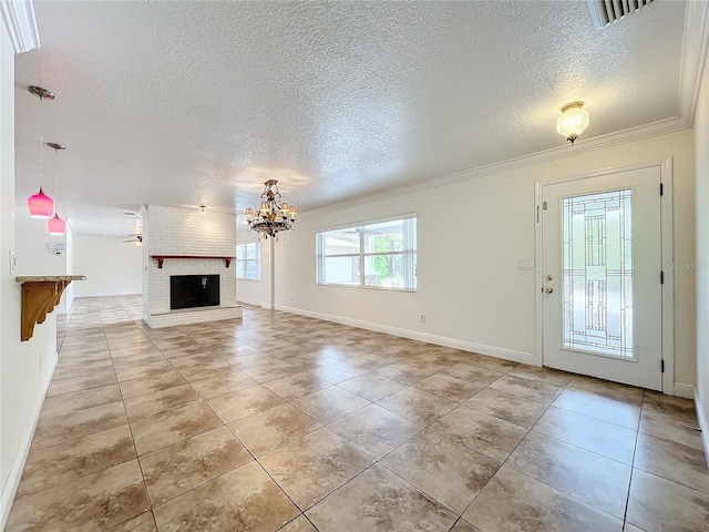 unfurnished living room with ceiling fan with notable chandelier, light tile patterned floors, crown molding, and a brick fireplace