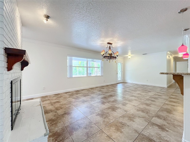 unfurnished living room with a textured ceiling, a fireplace, crown molding, and a chandelier