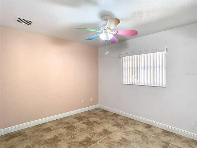 empty room with a textured ceiling and ceiling fan