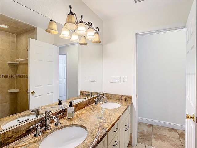 bathroom featuring tile patterned floors, vanity, and an inviting chandelier