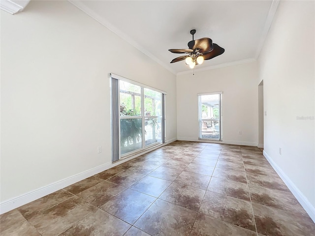 unfurnished room with ceiling fan, a towering ceiling, and crown molding