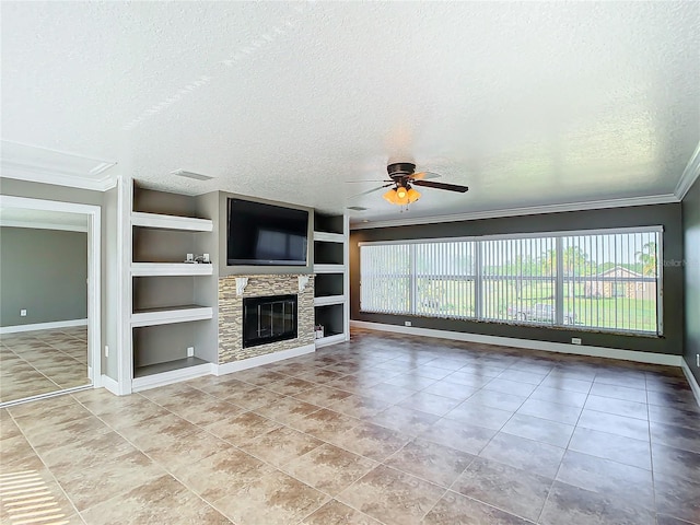 unfurnished living room with a stone fireplace, ceiling fan, built in features, and a healthy amount of sunlight