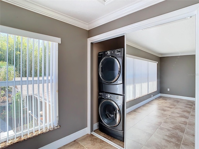 washroom with light tile patterned flooring, stacked washer / drying machine, and ornamental molding