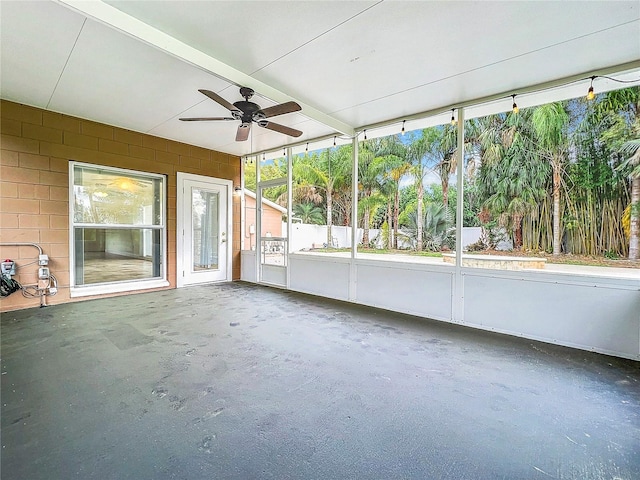 unfurnished sunroom with ceiling fan