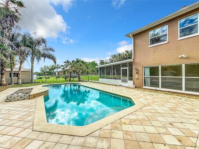 view of pool featuring a sunroom and a patio