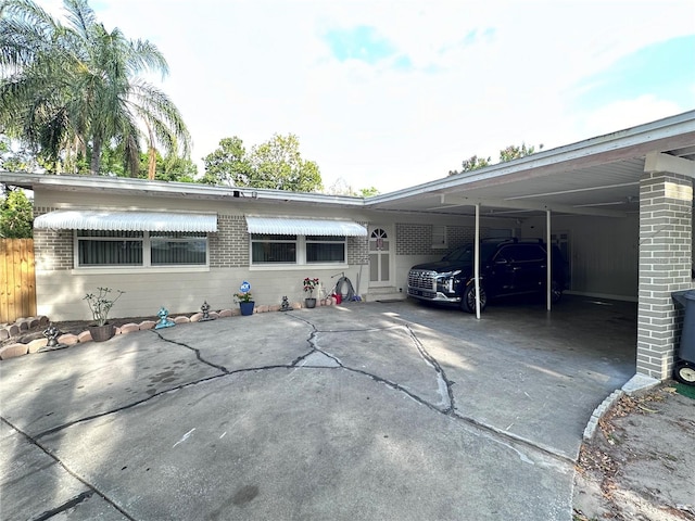 view of front of property featuring an attached carport and concrete driveway