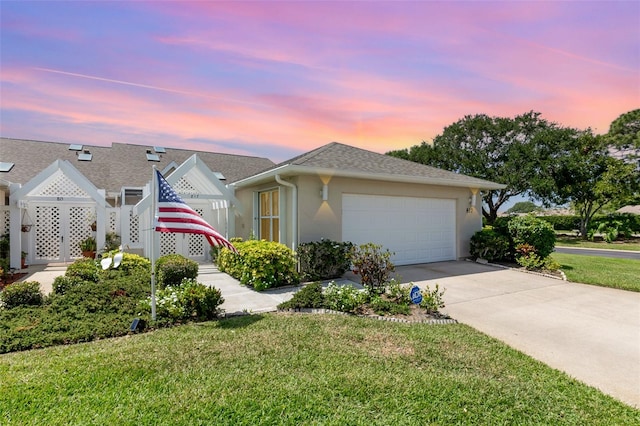 view of front of house with a lawn and a garage