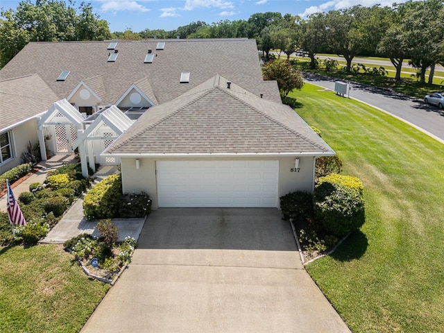 view of front of property with a front yard and a garage