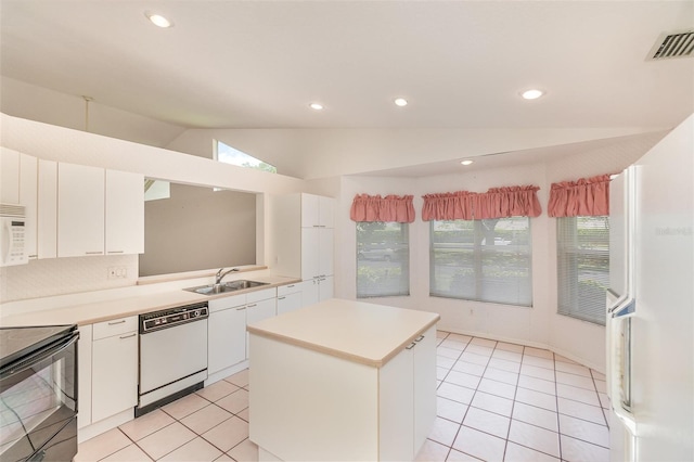 kitchen with a kitchen island, vaulted ceiling, white appliances, and white cabinetry