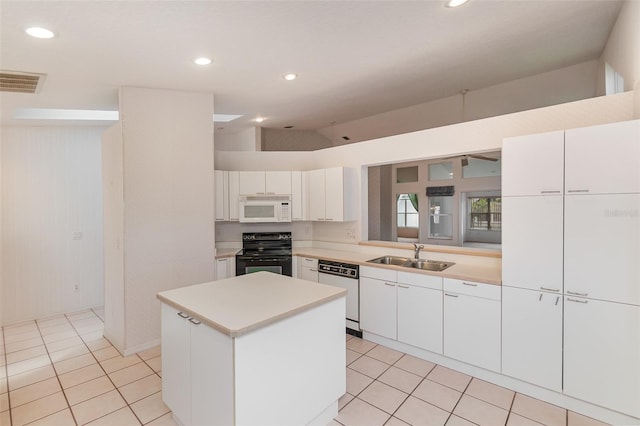 kitchen with white appliances, white cabinetry, and sink