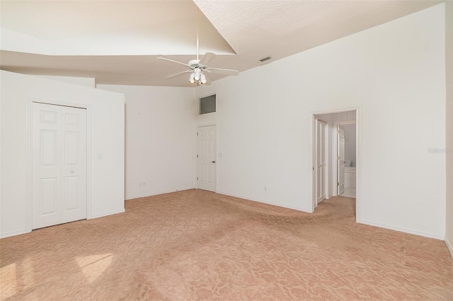 spare room with high vaulted ceiling and ceiling fan