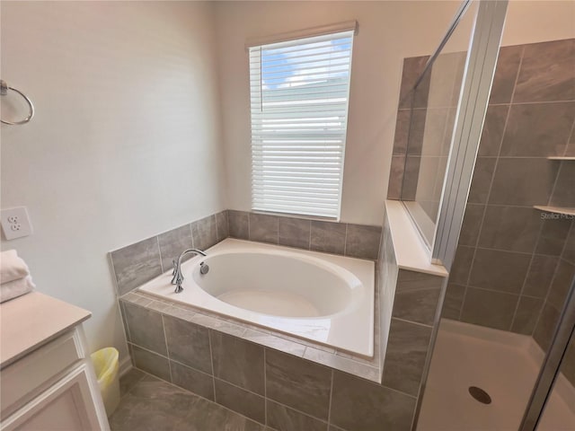 full bathroom featuring a tile shower, vanity, and a bath