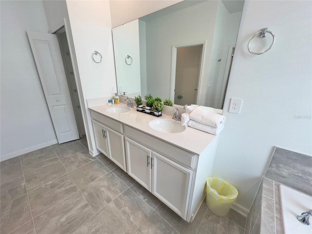 bathroom with double vanity, baseboards, and a sink