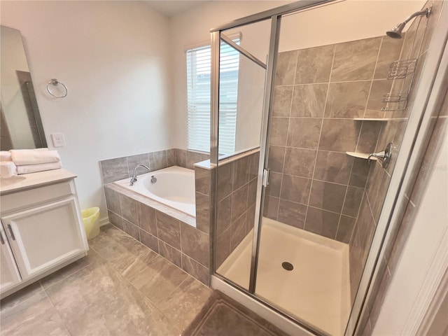 full bathroom with a stall shower, tile patterned floors, a bath, and vanity