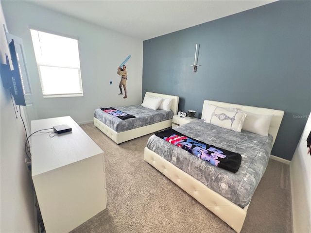 bedroom featuring carpet and baseboards