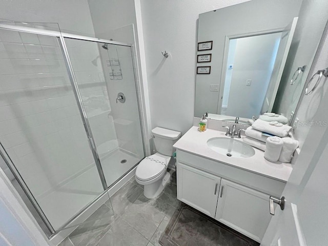 bathroom featuring toilet, a stall shower, and vanity