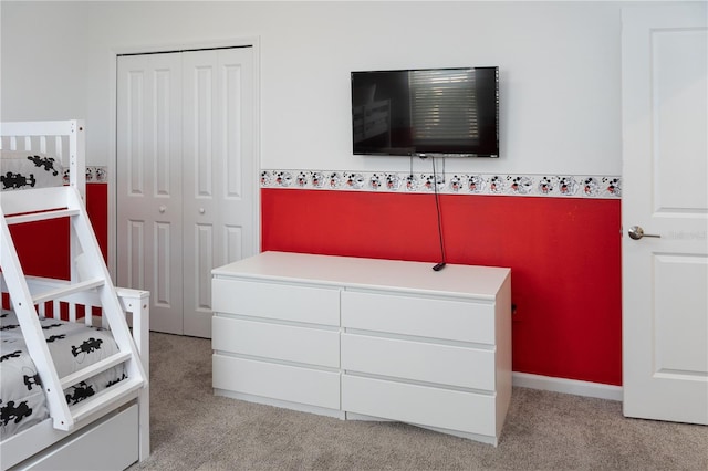 bedroom featuring a closet and light carpet