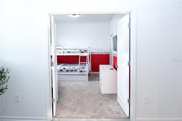 corridor featuring light colored carpet