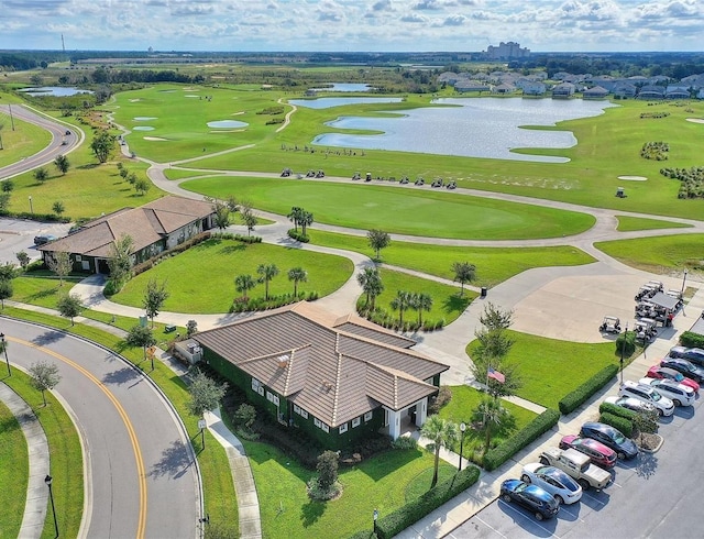 birds eye view of property featuring view of golf course and a water view