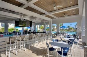 dining space with coffered ceiling and beamed ceiling